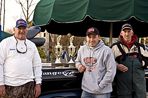 2008-Tourney-Winners: NASCAR driver Ryan Newman (center) with winners of the Ryan Newman Foundation Charity Fishing Tournament Alfred Kiesling, Sr. (left) and Cliff Kirby (right)in front of the grand prize Ranger Boat.  Photo Credit: Brad Bolton, Hindsight Photography