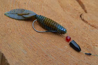 Rigging a beaver-style bait for shallow water starts with braided line and a round-bend hook. Add a glass bead between the weight and bait to create a clicking sound that adds attraction. Photo by Pete M. Anderson