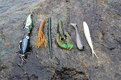 Smallmouth bass can see better when rivers run low and clear. That makes matching the hatch even more important. Small soft plastics, such as tubes and craws, and topwaters, such as small poppers and prop baits, imitate the easy targets they seek. Photo by Pete M. Anderson