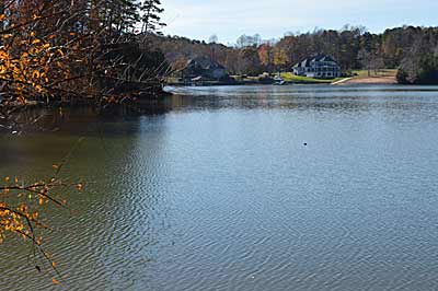 Isolated pieces of cover, such as this stump in open water, attract bass anytime, but especially during early summer’s post-spawn period and fall migrations. Mark them with a GPS waypoint or by points on shore, so you can return when the water level is higher.  Photo by Pete M. Anderson