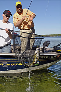 Matt Gnatkowski scoops up a good smallmouth for Dave Rose.