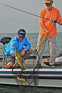 Scott Dobson removes a smallie for a net for Matt Straw.