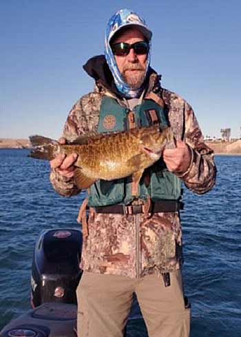 Match your lure choice to the current conditions, which dictate smallmouth activity. When the wind is blowing, Lake Havasu guide Cory Hoopes fishes fast-moving jerkbaits. When its calm and sunny, he slows down and fishes deeper with a jig. Photo courtesy of Cory Hoopes