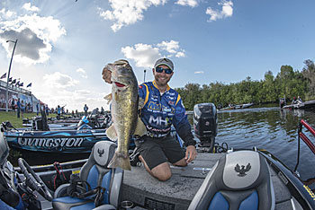 Bass like this one come from concentrating your casts on shoreline cover, such as riprap, docks, seawalls and green branches from overhanging trees that reach into the water, during the shad spawn.