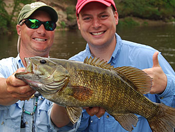 Chad Betts with a happy client and trophy river smallmouth. Image by bettsguideservice.com