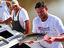 Tony admires a nice bass just before it makes its way into his newly renovated Indiana lake.