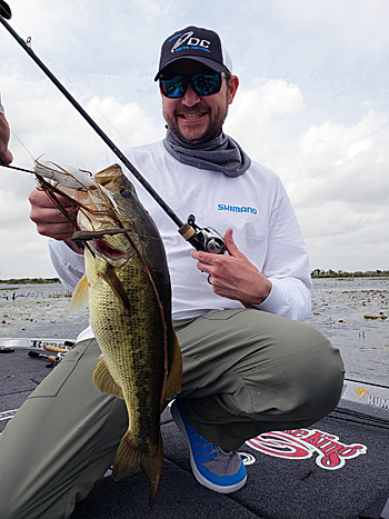 A bass caught by the author in a classic frog fishing location: lily pads and scattered vegetation with a solid white frog.