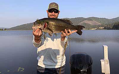 The author with a quality bass caught while fishing from the back of the boat.