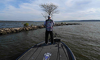 Oklahoma pro Fred Roumbanis looks for bass feeding on baitfish along wind-blown rocks.