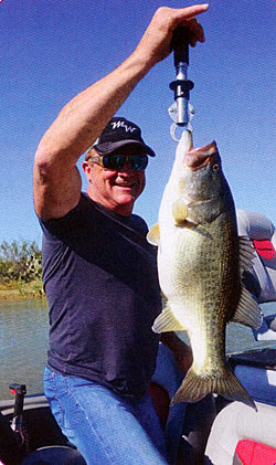 Dr. Gary Schwarz weighing a nice bass