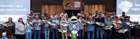 The 2022 Legacy Class ShareLunker anglers with their replica mounts.