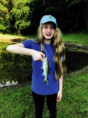 Happy child with a small bass (Photo Credit: P. Allen)