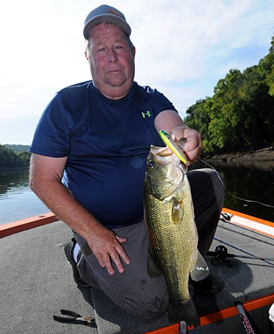 Topwater lures can trick bass below dams during the dog days of summer. 