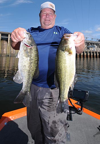 Guide Alfred Chapman takes his clients below Lake of the Ozarks’ Bagnell Dam to catch spotted and largemouth bass during the dog days of summer. 