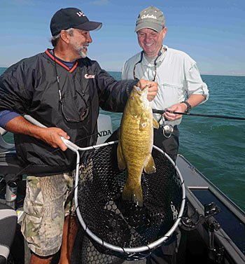 Guide Terry Jones (left) finds smallmouth bass on deep structure on the Great Lakes and shallow weeds in the Niagara River during the fall.