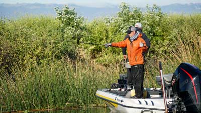 An angler getting ready to make a flip into cover.