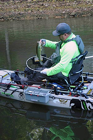 Jeff Mellencamp catches bass from his kayak on big lakes by fishing spots slowly and thoroughly.