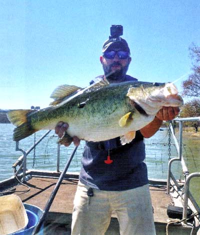 Ryan Young holding a 24-month-old 10-pound 4-ounce bass.