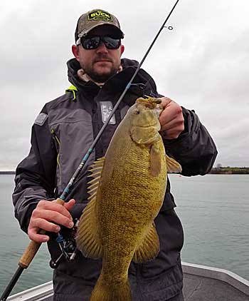 The author with a New York smallmouth on light line and spinning gear.