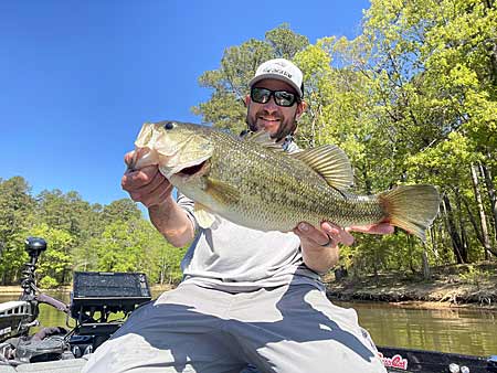 The author with a nice bass from North Carolina during his first visit to a new lake.