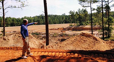 Frank James points to some of the features of his lake as it was being built.