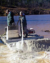 Liming the pond. Photo courtesy Greg Grimes