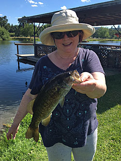 Jeannie Komorech with her 2 lb smallie by the covered dock