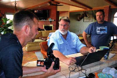 The Pond Boss, biologist Bob Lusk, pulls together a management plan for lake residents Ron McWilliams (L) and John Hand.