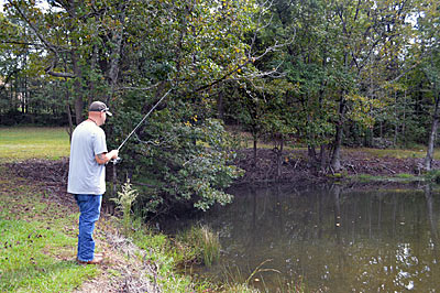 In clear-water ponds, bass will spook when they see or feel an angler approaching. So, stay back from the water’s edge and make long casts, which might need to partially cross land. Photo by Pete M. Anderson