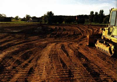 The bulldozer did its magic along with a pan scraper to shape the pond and build up the low elevations with a short dam.