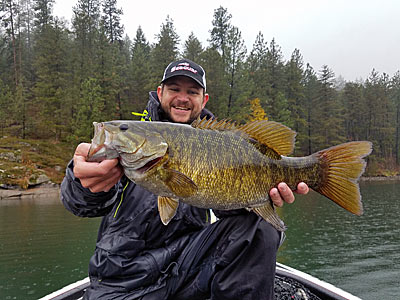 The author, with his personal best smallmouth bass that fell for a swimbait on a rainy late fall day.