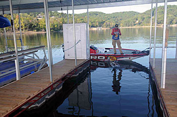 Pitching a flutter or slab spoon into dock wells is an effective tactic to catch summertime bass.