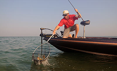 Dragging a tube bait for summertime smallmouth bass requires spinning tackle and 8-pound test line.