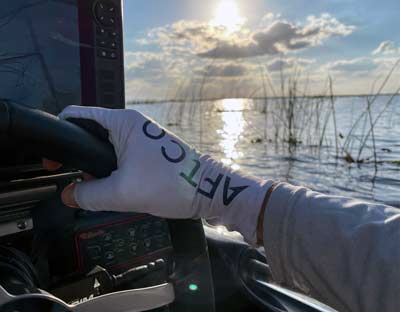 Sun gloves, like the AFTCO Solago sun gloves, protect your skin. Once you get used to wearing them, you can fish comfortably and just as effectively as you can without wearing gloves.