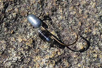 Sound will make your tube jig more attractive to bass. While some lead heads are made with rattles, it’s easy to add your own glass worm rattle with some thread and glue. Photo by Pete M. Anderson