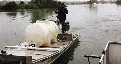 Fisheries biologist Paul Dorsett on one of the alum application boats.