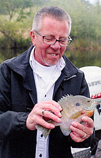 General manager Tim Spence with a nice bluegill captured during the sur-vey. These are the backbone of the food chain for largemouth bass.