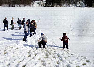 These college students are checking oxygen levels under snow-covered ice to learn how winterkill happens. Courtesy Mark Cornwell 